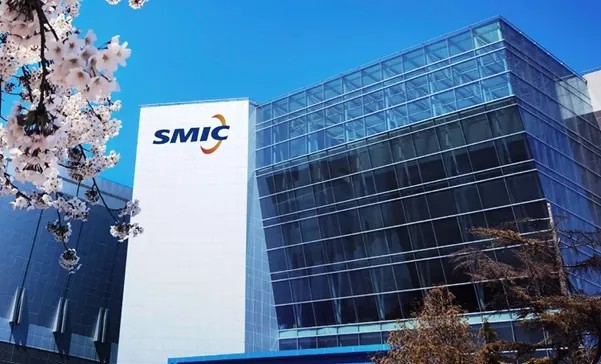 SMIC's headquarters, a blue glass building carrying the SMIC logo, framed by cherry blossoms.